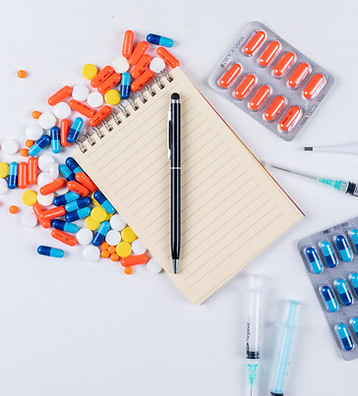 top-view-colorful-pills-with-notepad-pen-thermometer-nasal-spray-needle.jpg