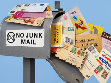 junk mail overflowing out of a mailbox that reads: No Junk Mail