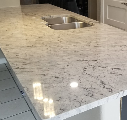 White Thunder polished granite countertop with undermount sink and natural veining, fabricated and installed by Counter Source in San Antonio, TX