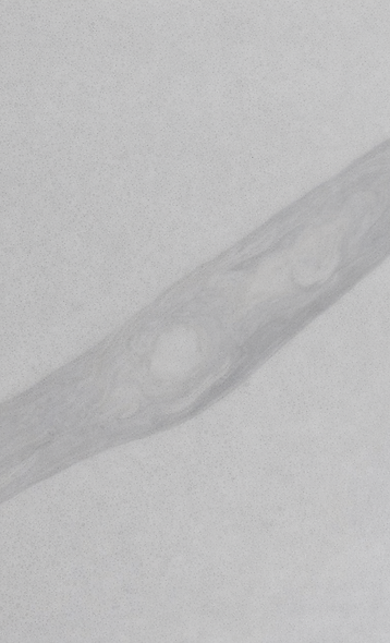 Graphite Vein Quartz close-up – soft graphite-toned vein detail on a smooth white base