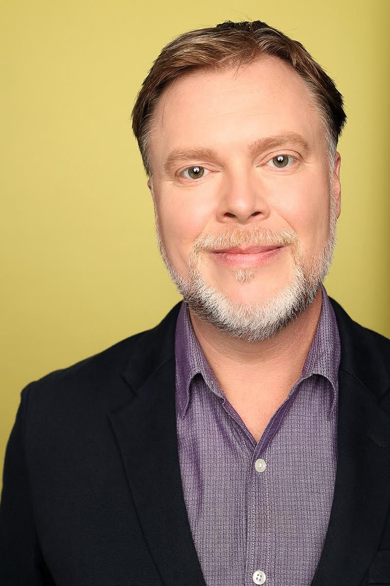 A man smiles at the camera