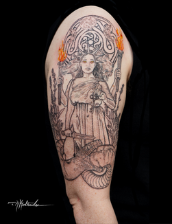 Custom tattoo, illustrative tattoo on bicep of Greek goddess Hecate holding a dagger, key, and two lanterns with three moon phases, ornamental pattern, and lavender in the background. Hecate has three heads, one is human, one is a dog, and one is a lion. Tattoo by Tyler Kaltreider ( T. R. Kaltreider ) at Toad and Jaguar Tattoo on Vashon Island