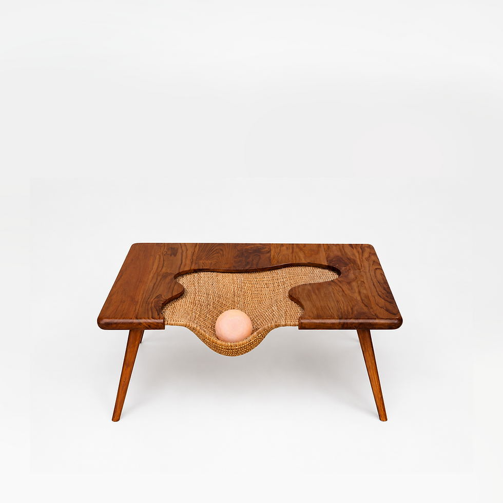Front view of square coffee table in teakwood with organic rattan detail on the tabletop and legs in teakwood.