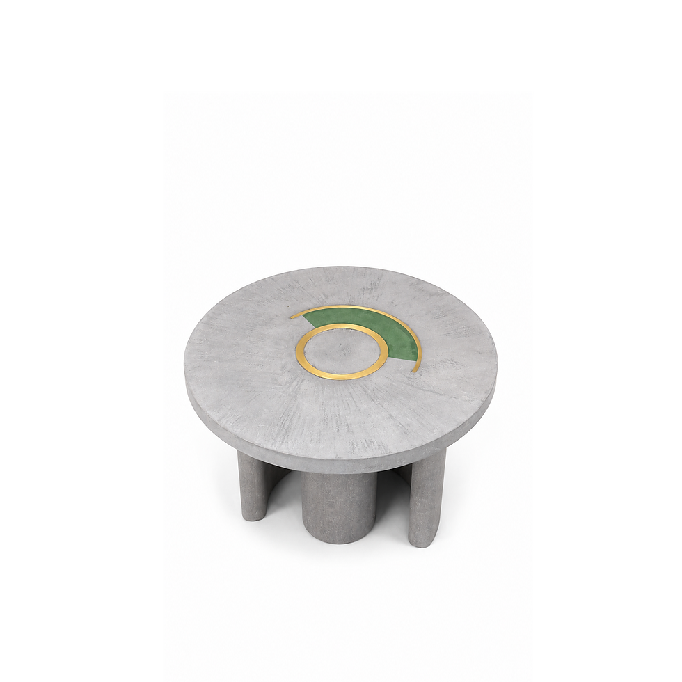 Top view of round coffee table in concrete with geometric brass inlay, green accent detail on tabletop and cylindrical legs.