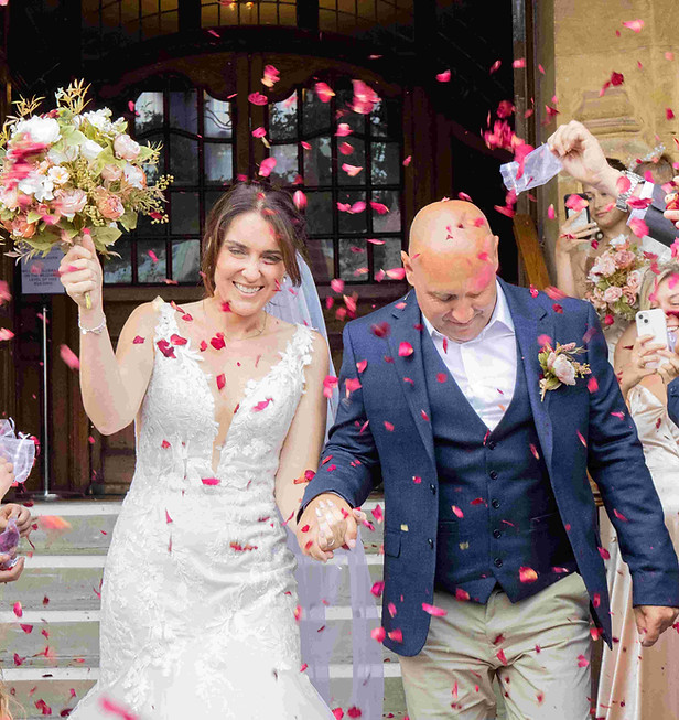 A bride and groom in a shower of confetti outside Lynton Town Hall