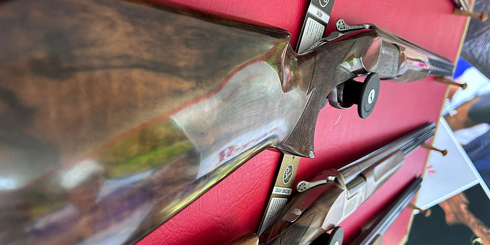A close up of the stock of a Perazzi shotgun on display