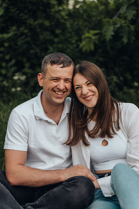 a man and a woman are posing for a picture and smiling