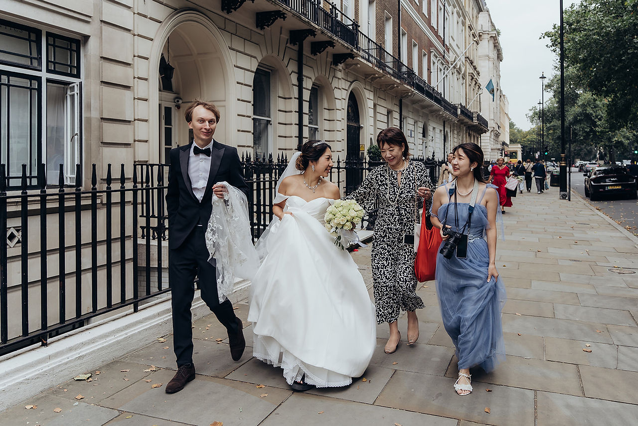 After the ceremony, we embarked on a breathtaking journey through some of London’s most picturesque locations. Our first stop was Park Crescent, where the couple posed gracefully against the backdrop of elegant Regency architecture. The stunning symmetry and classic style of the crescent provided a timeless aesthetic for their wedding portraits.  From there, we moved to Regent Street, capturing candid and romantic moments amid the hustle and bustle of London’s vibrant heart. The grand buildings and festive atmosphere made for striking wedding photography, blending modern energy with timeless romance.  To round off the day, we traveled to Westminster, where Vadim and Yu stood before some of London’s most recognizable landmarks. From Big Ben to the Houses of Parliament, every shot captured the essence of their love story in the city’s most iconic settings. These final moments created breathtaking memories that will last a lifetime.