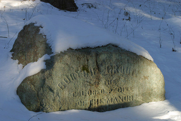 A stone boulder marking the burial ground’s location, placed in the later 19th-century.