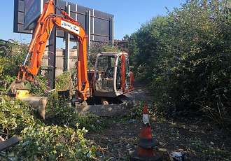 An Excavator carrying out ground clearance works