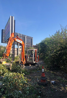 An excavator clearing grounds