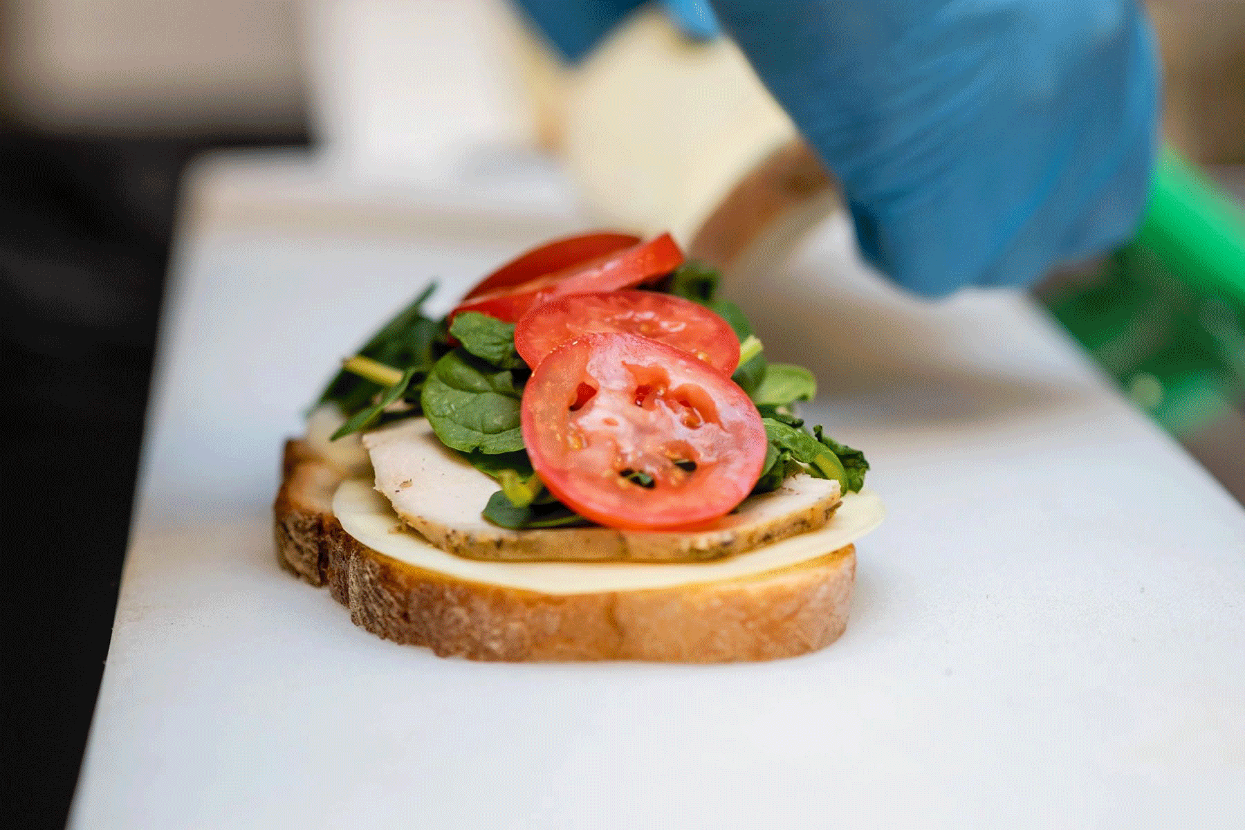 A Chicago-style deli sandwich and a bowl of soup in a rotating display of images
