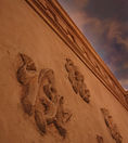 Carved plaster wall with raised relief and airbrushed sky