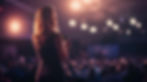 large-a-woman-is-standing-in-front-of-a-crowd-at-a-conference.jpeg