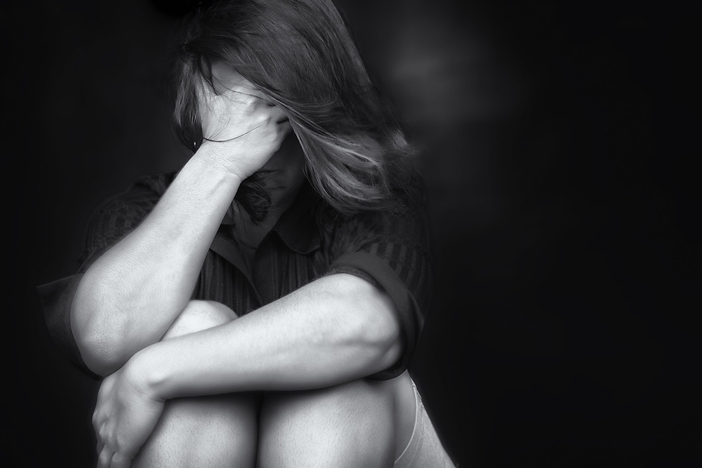 Woman crying with a dark background