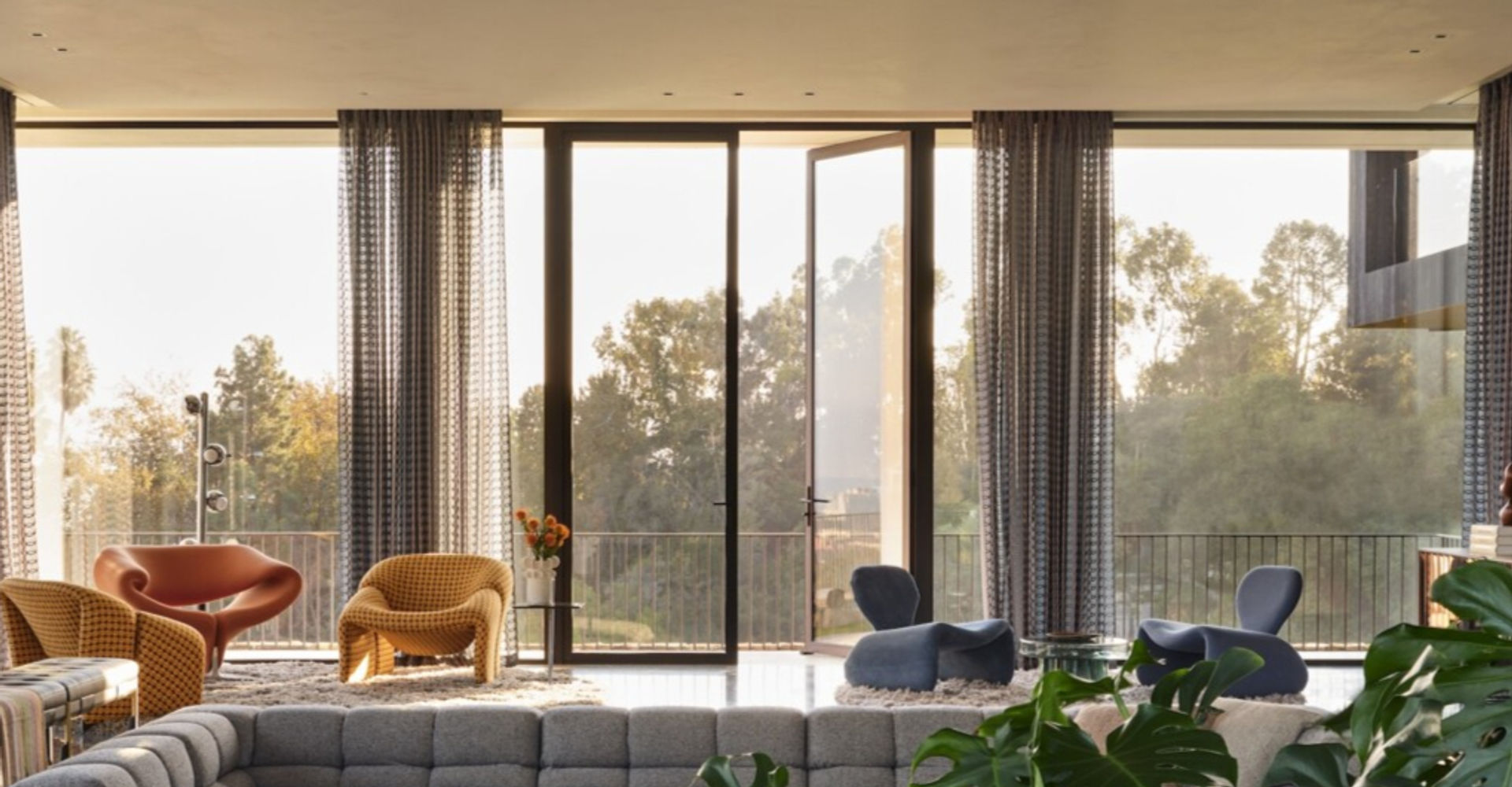 Interior living space with floor-to-ceiling minimal frame windows showing mountain views