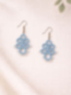 Powder sky handmade tatting earrings by Knots to Node on a white textured fabric background