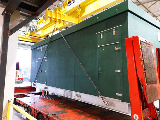 Green GRP enclosure being mounted on the track for the delivery.