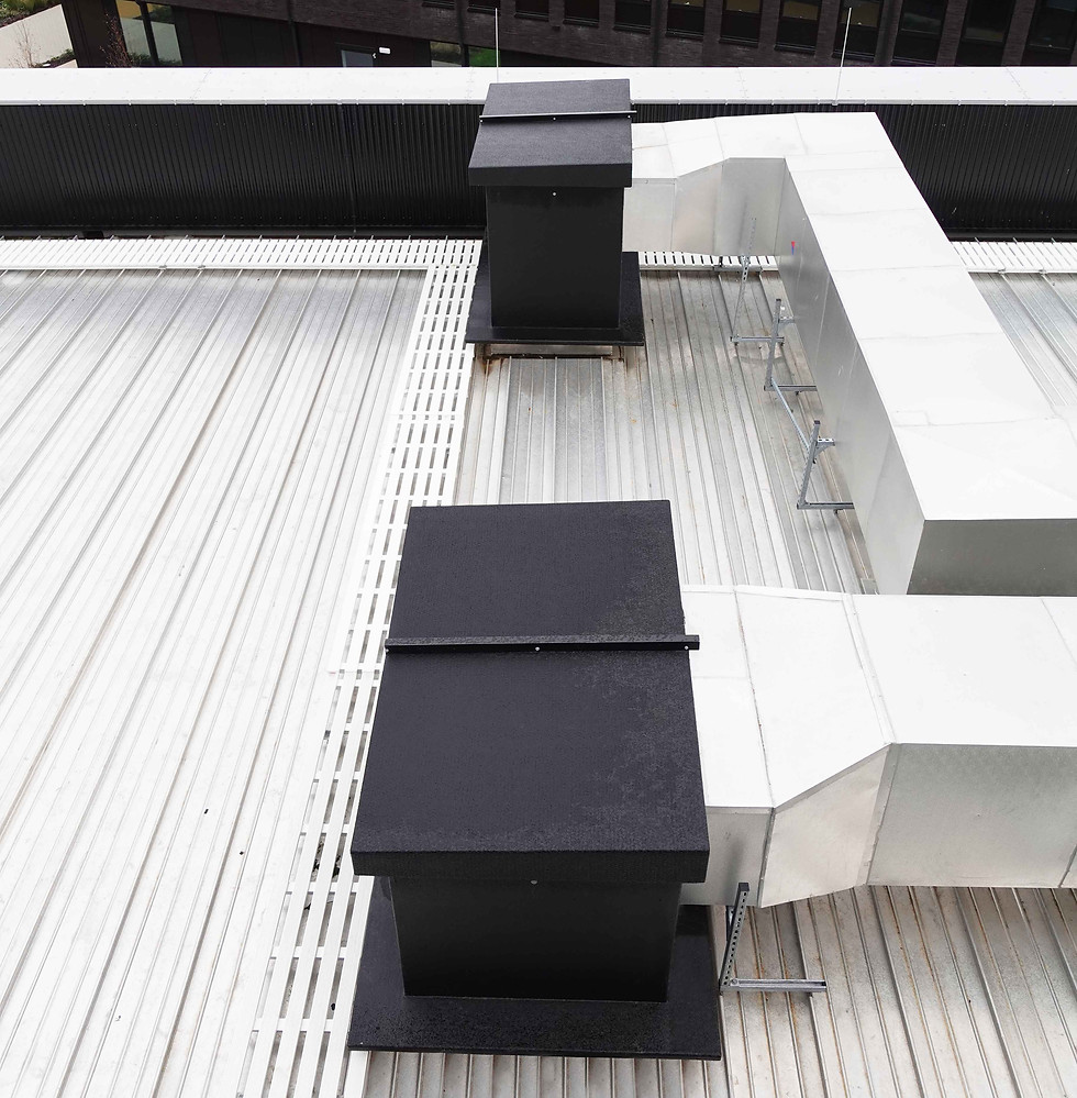 Two black TopBox roof entry system kiosks on top of the metal roof with the electrical containments