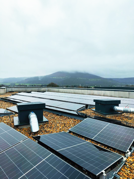 Black TopBox Roof Entry Systems installed in between solar panels on the top of the roof
