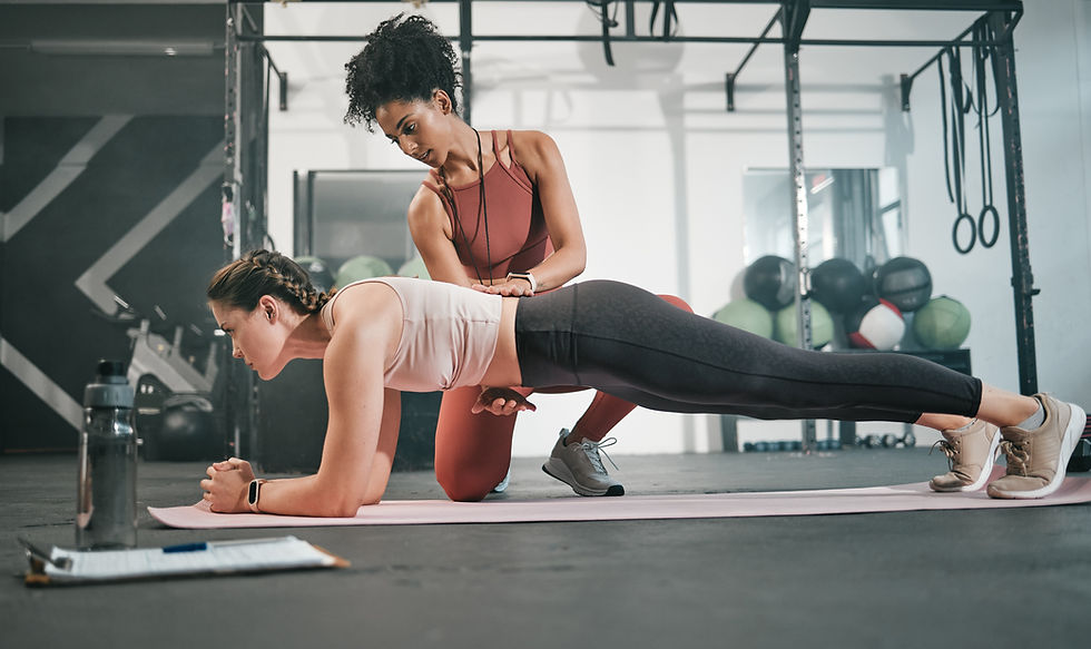 personal trainer working with a postpartum client on core strength