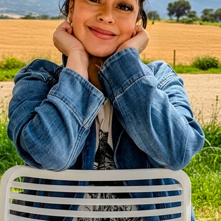 Ali wearing a Gigi Pip hat in a country setting background.