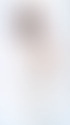 The Airport Arrival: A woman in a light beige FP Movement onesie over a white t-shirt, wearing white boots and taking a mirror selfie.