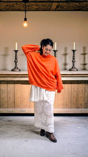 Vintage lace tablecloth skirt. Ali in front of brass candleholders