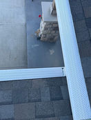 White gutters installed on a shingle roof