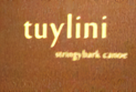 Text on a brown background reads "tuylini" and "stringybark canoe" in yellow. The image is simple and focused on the text.