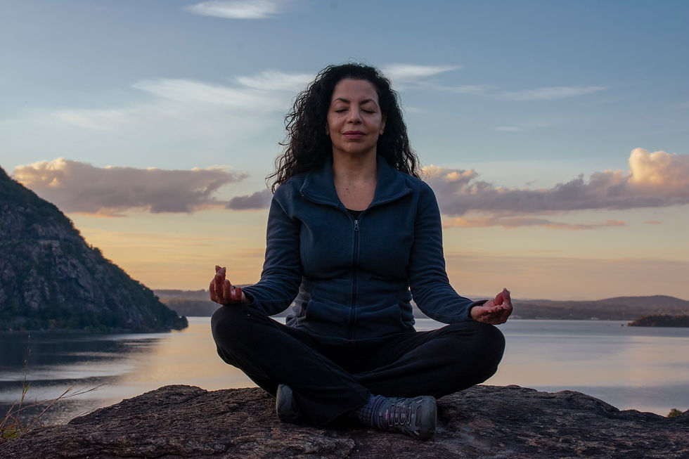 Woman meditating in front of Hudson River