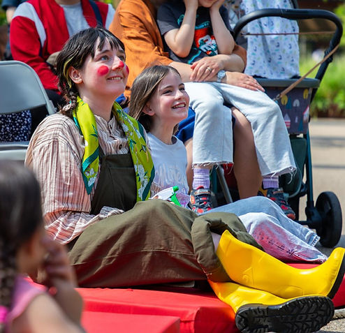 Clown performer and child in audience