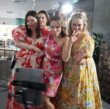 Guests using 360 photo booth they hired for a party