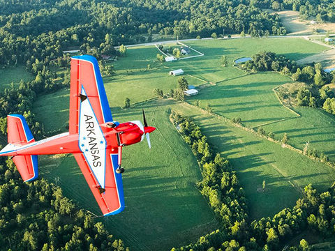 Airplane flying above rural Northwest Arkansas