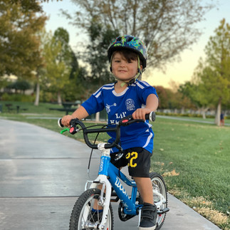 3 year old learning how to ride a bike on a Woom