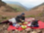 Father and son share a traditional Moroccan lunch outside in the Atlas Mountains on a trek