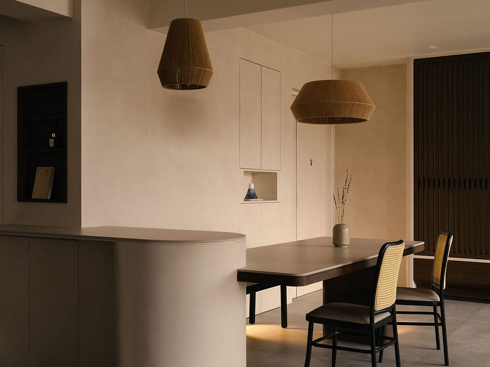 Japandi-inspired dining area; a specially tailored kitchen peninsula with integrated dining table in comforting rosy beige tones.