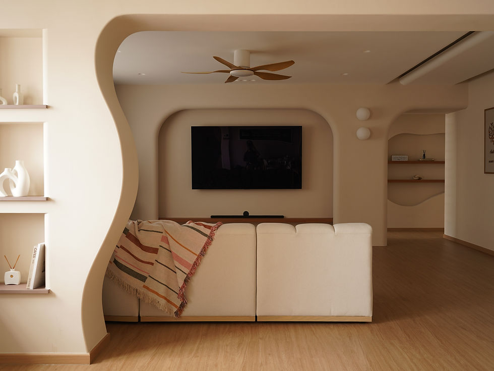 Living room with curved TV feature wall.