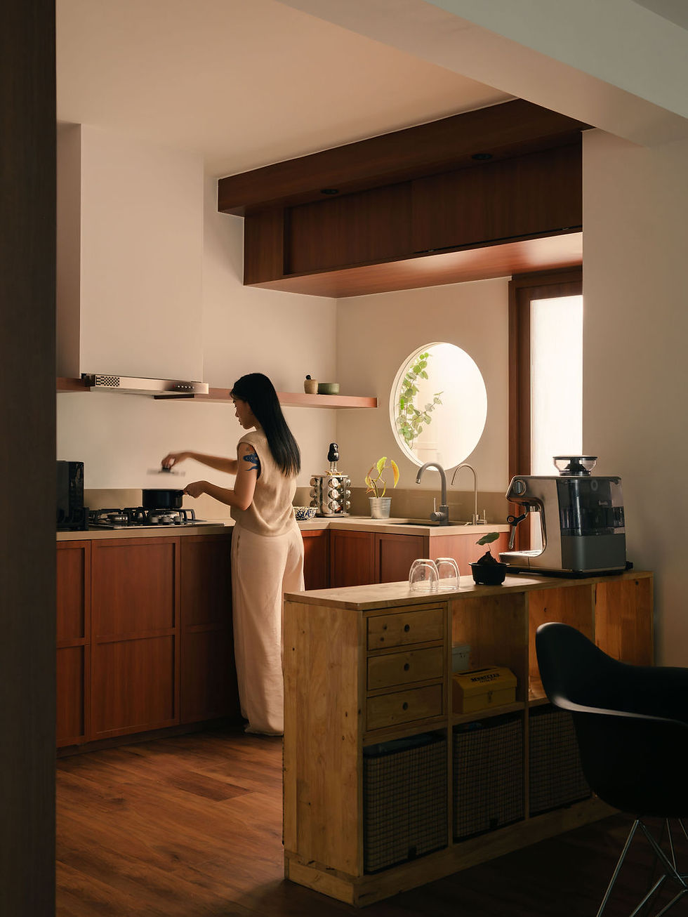 cooking in an open-concept kitchen; coffee machine on a slim rack; mid-century modern interior