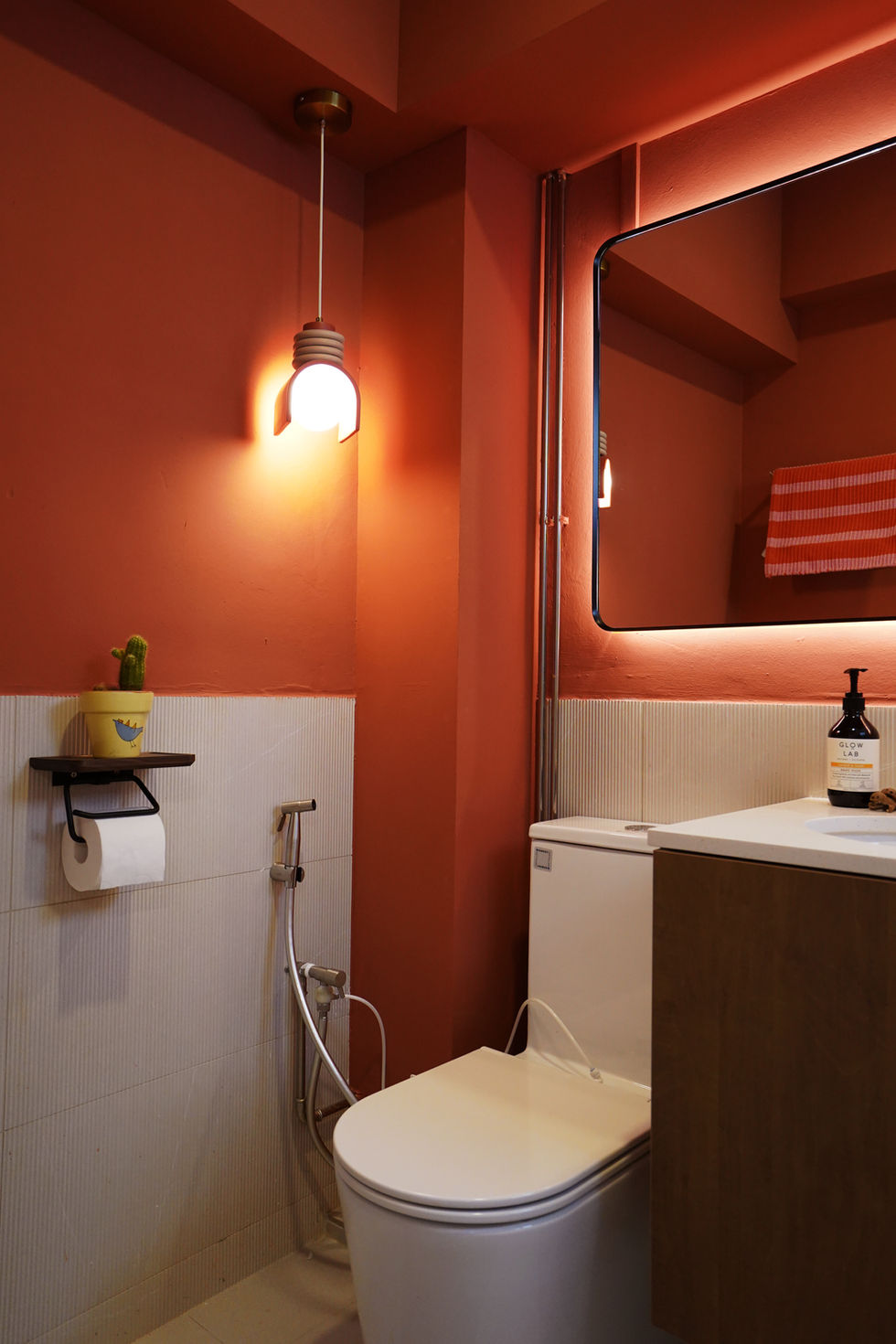 A bathroom with half-tiled walls