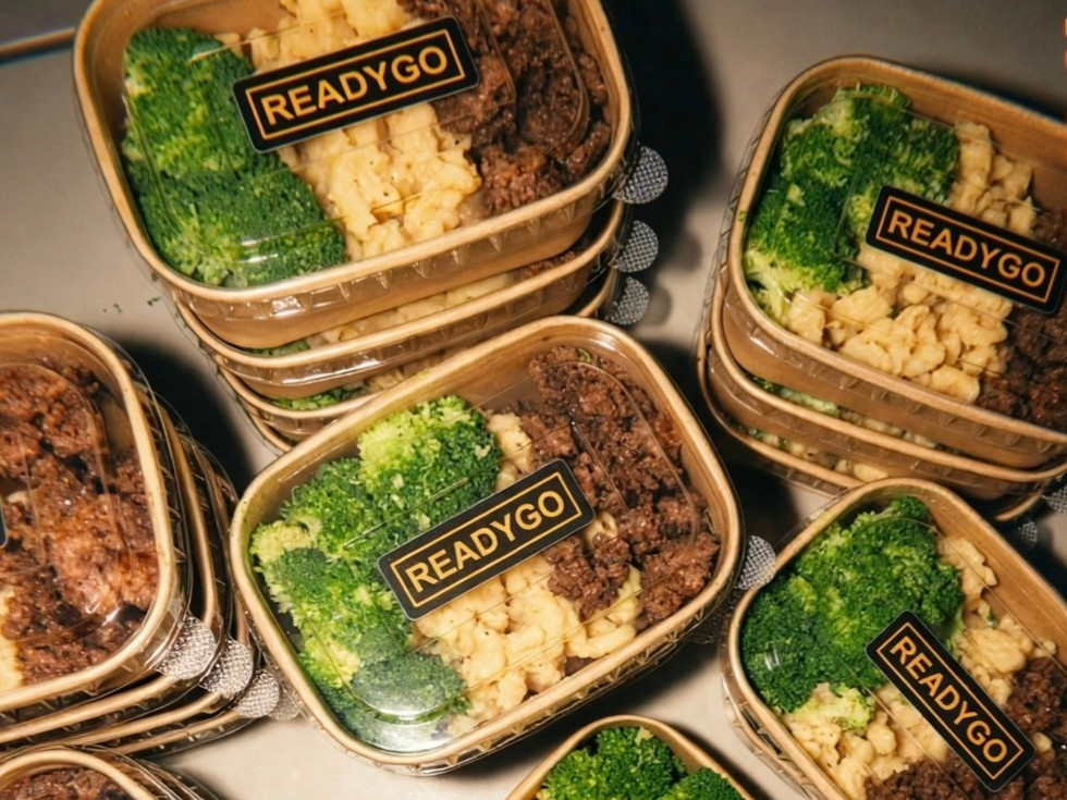 Close-up view of a prepared endurance meal with rice, lean protein, and vegetables in a meal prep container.