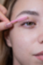 Caucasian woman brushing her eyelashes after lamination _edited.jpg