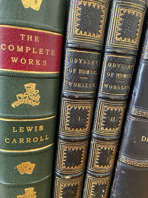 Three antiquarian books which are all fine bound in leather. Features the Compelte Works of Lewis Carroll and Homer's Odyssey in two volumes translated by Worsley.