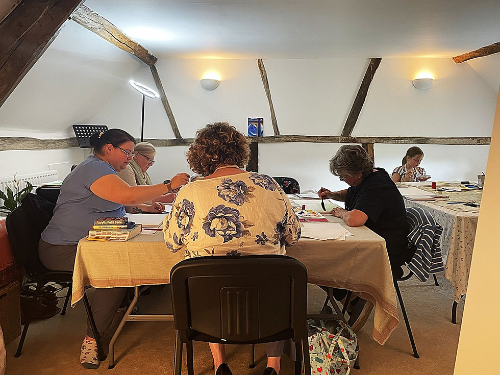 Art retreat in The Wellspring Ledbury meeting room, with participants painting at tables beneath exposed beams
