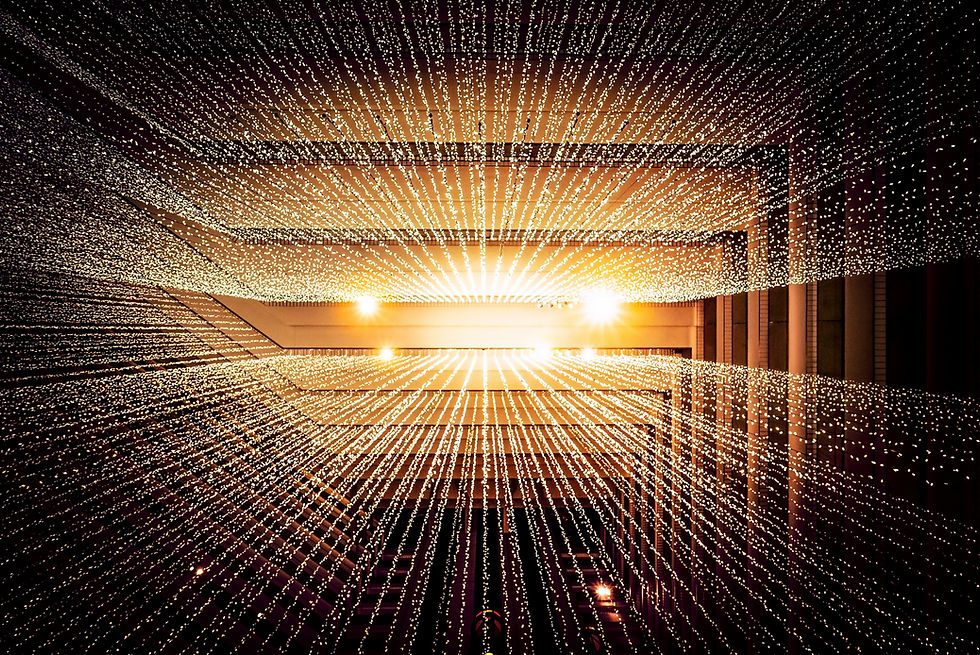 A striking display of rows of lights extending into the distance, creating an abstract visual effect of light beams in a modern architectural setting.