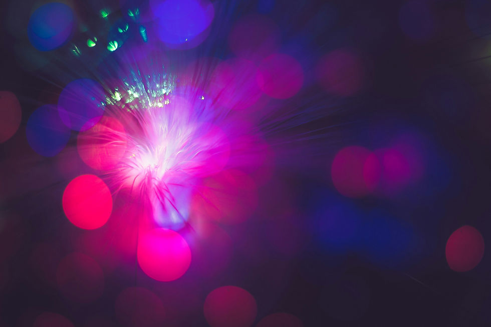 Abstract image with vibrant pink, purple, and blue light bokeh effects creating a dreamy and futuristic atmosphere.