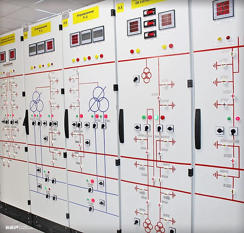 Engineer monitoring control room panel for instrumentation and controls services at industrial facility