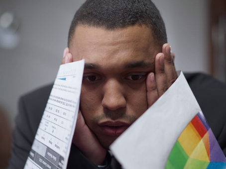 Man with hands on his forehead feeling overwhelmed and burnt out
