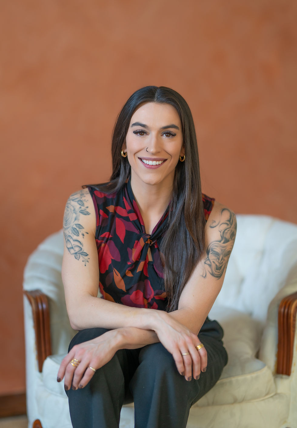 Mikayla Lanoie smiling, seated in a white armchair