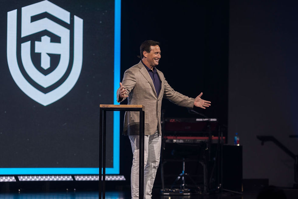 Jon Gordon on stage giving his keynote message.